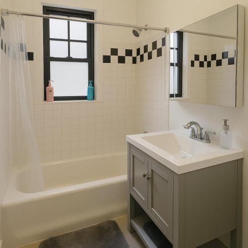 a bathroom with a sink and a bath tub and a sink at 1BR Fully Equipped & Central - Belmont rep in Chicago