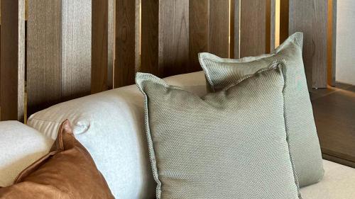a white couch with two pillows on it at Agnadema Apartments in Firostefani