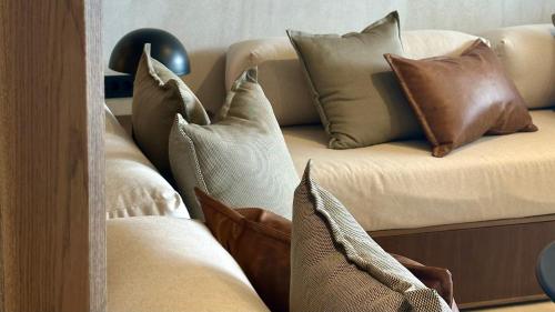a couch with a bunch of pillows on it at Agnadema Apartments in Firostefani