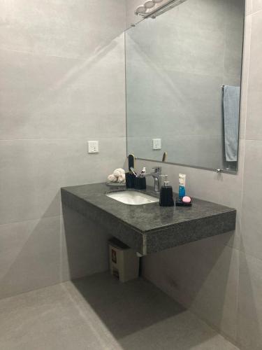 a bathroom with a sink and a mirror at Scenic Cozy Retreat in Islamabad in Islamabad