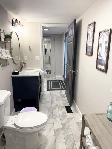 a bathroom with a toilet and a sink at Little Bit-A-Cozy, 2BR Retreat in Hickory
