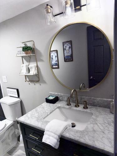 a bathroom with a sink and a mirror at Little Bit-A-Cozy, 2BR Retreat in Hickory
