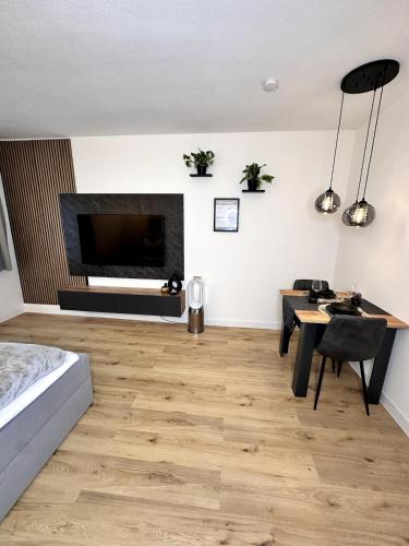 a living room with a fireplace and a bed and a table at City Apartment Bad Aussee in Bad Aussee
