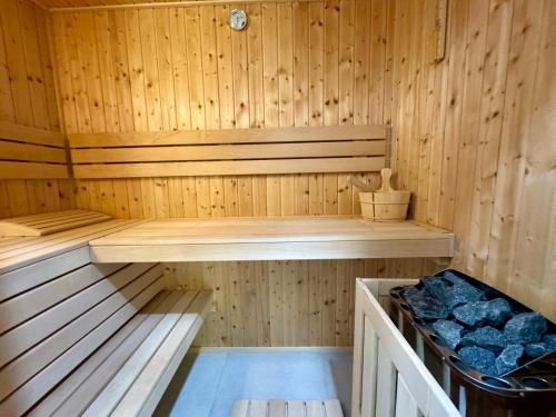 a wooden sauna with a wooden bench in it at Sauna y in Cluj-Napoca