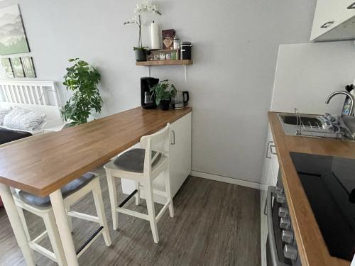 a kitchen with a wooden table and two stools at Ferienwohnung in Freudenstadt-Kniebis I, Schwarzwald in Freudenstadt