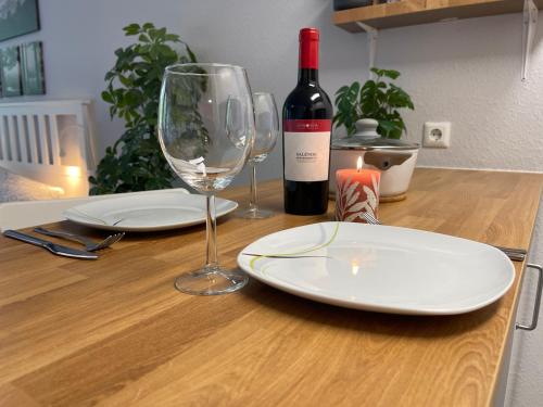 a table with two glasses and a bottle of wine at Ferienwohnung in Freudenstadt-Kniebis I, Schwarzwald in Freudenstadt