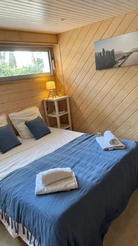 une chambre avec un lit avec des serviettes dessus dans l'établissement Villa La Dune aux Loups, à Saint-Jean-de-Monts