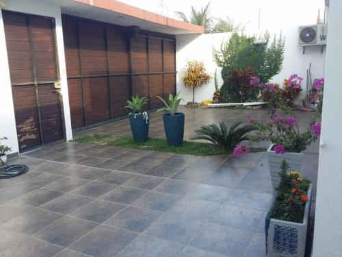 a patio with potted plants in front of a house at The Hidden Gem in Santa Cruz de la Sierra