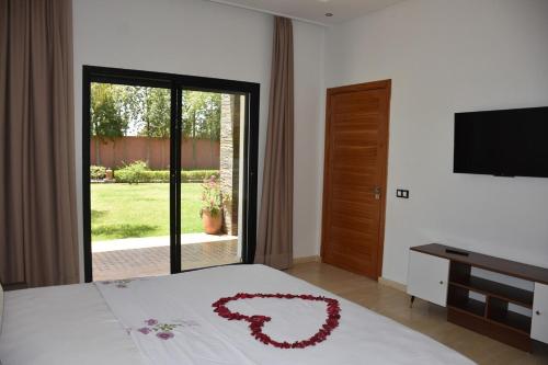 a bedroom with a bed with a red heart on it at Villa Denalya in Marrakech