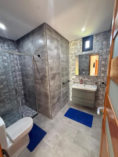 a bathroom with a shower and a toilet and a sink at Villa Denalya in Marrakech