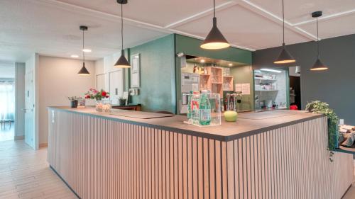 a bar in a room with a counter top at Campanile NATURE - Dreux in Dreux
