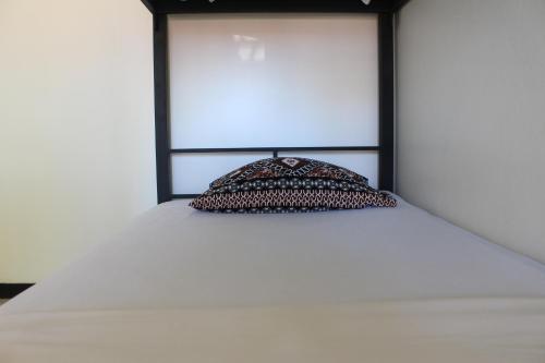 a pillow sitting on top of a bed at Bamboo Backpackers in Nadi
