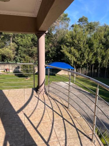 a fence with a blue canopy in a park at The Serene Gift in Mbabane