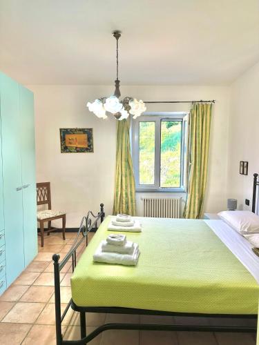 a bedroom with a green bed and a window at La Spezia Vezzano 5 terre - Il Ciliegio in Vezzano Ligure