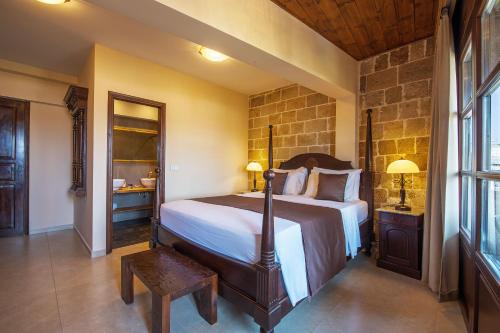 a bedroom with a large bed in a room at S.Nikolis' Historic Boutique Hotel in Rhodes Town