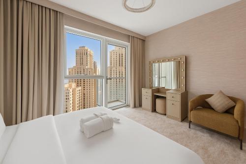 a bedroom with a large bed and a large window at La Vie, JBR, Dubai in Dubai
