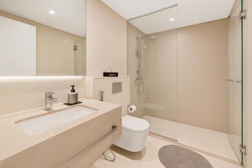 a bathroom with a sink and a toilet and a shower at La Vie, JBR, Dubai in Dubai