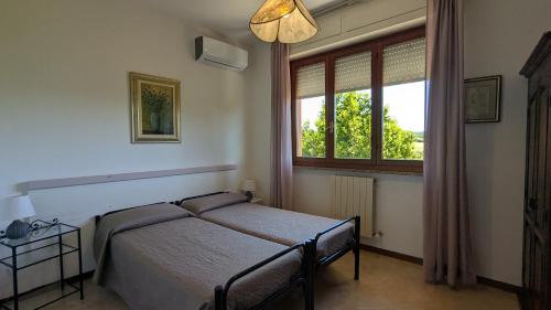 a bedroom with a bed and a window at Casa Rurale in San Vincenzo