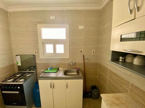 a small kitchen with a sink and a stove at Cairo Madinty 2 in Madinaty