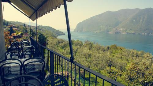 a balcony with chairs and a view of a lake at B&B Tina in Monte Isola