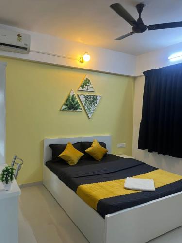 a bedroom with a bed with a ceiling fan at Luxurious 3bhk Apartments in Pune