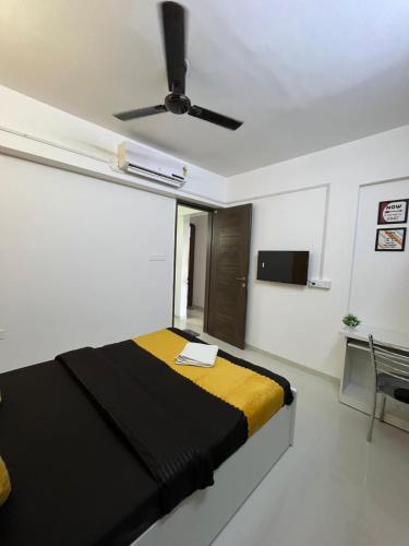 a bedroom with a bed and a ceiling fan at Luxurious 3bhk Apartments in Pune