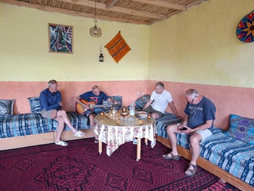 a group of men sitting on a couch in a room at KASBAH Atlas-Aberdouz in Aït Hattab