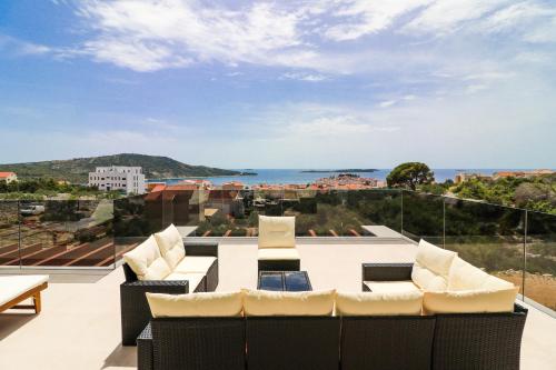 a balcony with furniture and a view of the ocean at Villa Golden Lion in Primošten