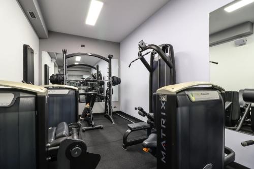 a gym with treadmills and elliptical machines at Villa Golden Lion in Primošten