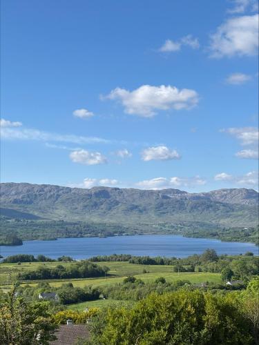 a view of a lake with mountains in the background at Rose Cottage at Hilltop Hideaway in Barnesmore