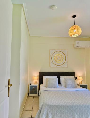 a bedroom with a large bed with two night stands at Sophilia Garden escape in Patra