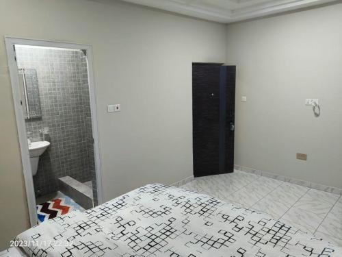 a white room with a bed and a shower at 2 bedroom Apartment - East legon in Accra