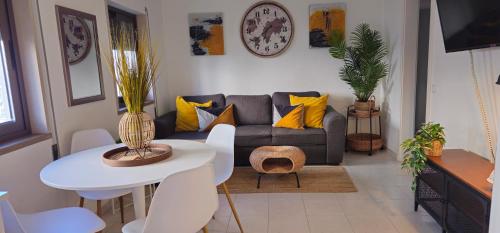 a living room with a couch and a table at Casa dos Sinos 2Bedroom Beach Apartment with Terrace in Albufeira