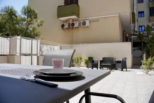 a table with a plate and a glass on it at Casa al mare - Puglia Mia Apartments in Monopoli