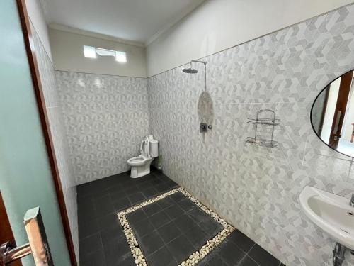 a bathroom with a sink and a toilet at D Teba Ubud Villa in Ubud