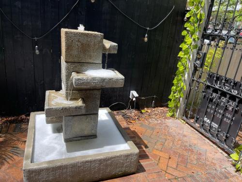 a statue sitting on top of a brick sidewalk at Romantic Studio Apt in Historic Downtown Savannah in Savannah