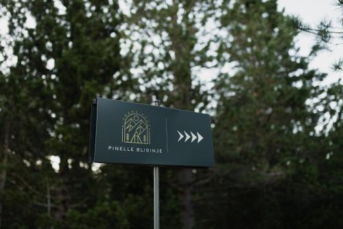 a sign for a park with trees in the background at Pinelle Blidinje A-Frame House in Risovac