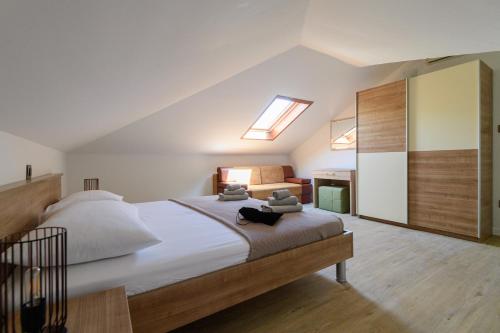 a bedroom with a large bed with a skylight at Apartments Kralj Ana in Cavtat