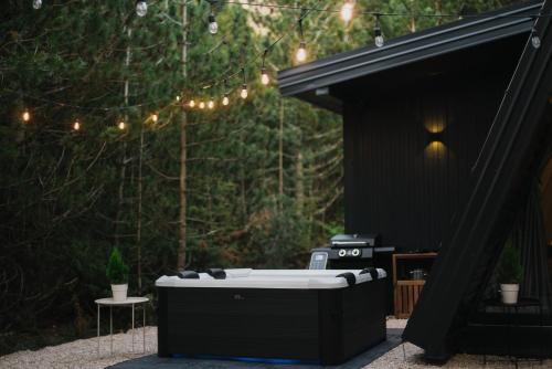 a bath tub sitting in the middle of a patio at Pinelle Blidinje A-Frame House in Risovac