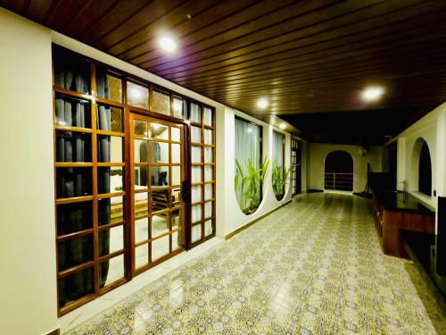 an empty hallway with windows and a tiled floor at Roys Villa Havelock in Havelock Island