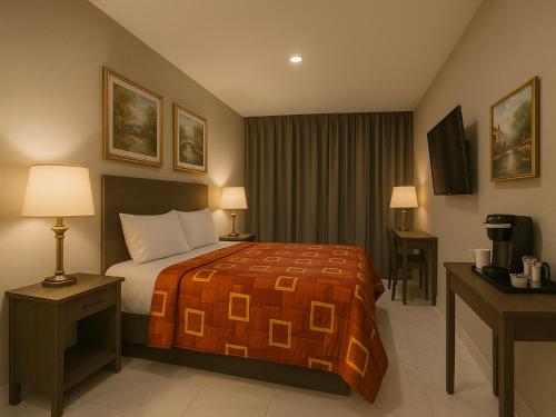 a hotel room with a bed and a television at Hotel Fuego Bronx YANKEE STADIUM in Bronx