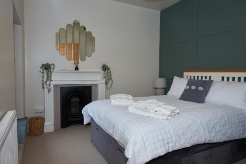 a bedroom with a bed with towels on it at No32 Carmarthen Road in Llandeilo