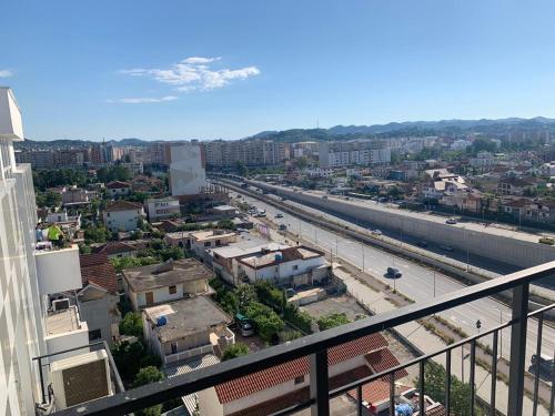 a view of a city from the balcony of a building at Tirana Magnifique Apartments in Tirane