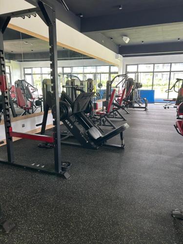 a gym with rows of treadmills and machines at La Marquise sky two rooms apartment in Moka