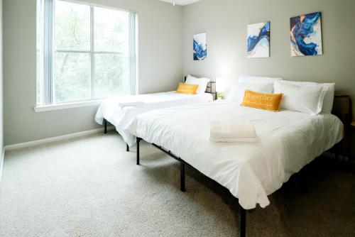 two beds in a bedroom with a window at Cozy 1,100sf apartment in the heart of Legacy in Plano
