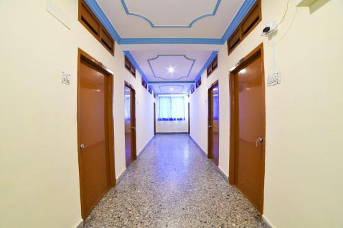 an empty corridor with a blue ceiling in a building at Hotel O Radika Residency in Warangal