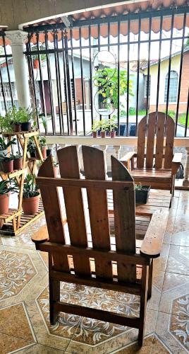 two wooden benches sitting in a room with plants at A Piece of Sun in Panama City