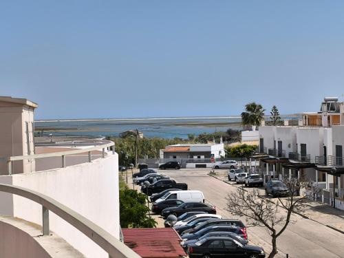 a row of cars parked in a parking lot at Santa Rita Guest House in Olhão
