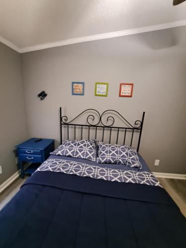 a bedroom with a bed with a black and white bedspread at Private country getaway in Wake Forest