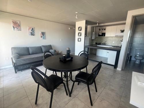a living room with a table and chairs and a couch at Departamento Ambar PERICO in Perico